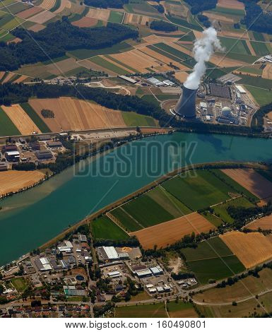 nuclear power plant with a bird's-eye view. pollution of ecology against the background of cultivated fields near the river