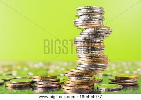 Business and investment financial concept. Golden money coins on table with trading graph background.