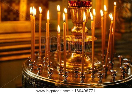candles and icon in russian orthodox church interior