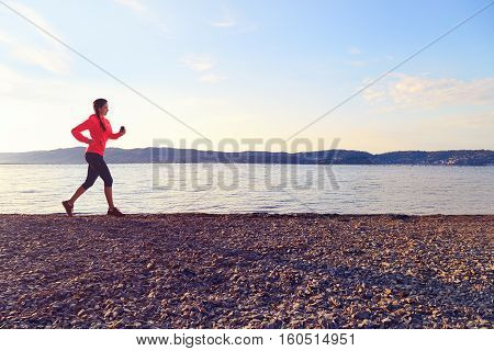 Young Fitness Woman Running Outdoors Near Sea.