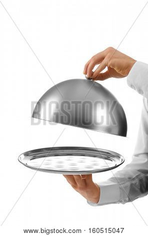 Male waiter holding cloche and tray on white background