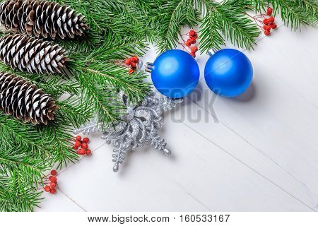 Christmas New Year composition with tangerines, cones, nuts, wicker basket and fir branches in rustic style on old wooden background, selective focus, Background new year, fir, gift, cones, orange, blue ball, red background, snow, ,