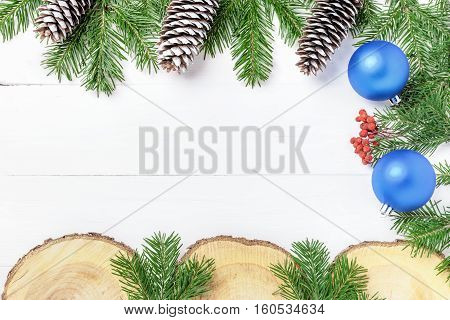 Christmas New Year composition with tangerines, cones, nuts, wicker basket and fir branches in rustic style on old wooden background, selective focus, Background new year, fir, gift, cones, orange, blue ball, red background, snow, ,