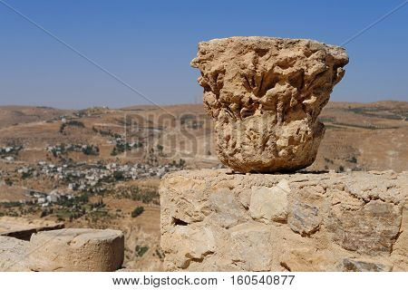 Weathered column capital on the ruins of medieval Kerak castle in Jordan