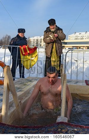 Priest Consecrates The Ice Hole On Epiphany Day. Russia