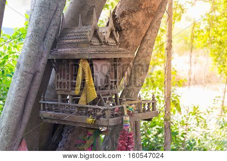 Ancient Thai outdoor spirit house shrine Thai style made from wood. In tradition Thailand all spirit houses are kept outdoor for protect house.