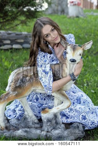 girl in a long dress with her hair with a fawn
