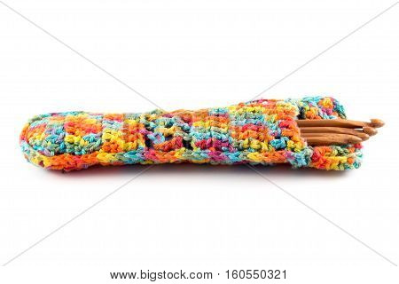 Wooden crochet hooks in crochet bag isolated on white background