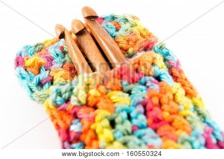Wooden crochet hooks in crochet bag isolated on white background