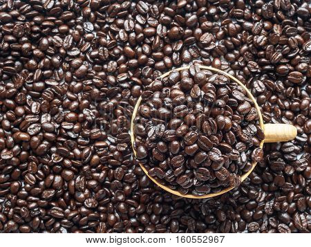 Roasted coffee beans color brown in cup and background with copy space of top view for texture pattern background