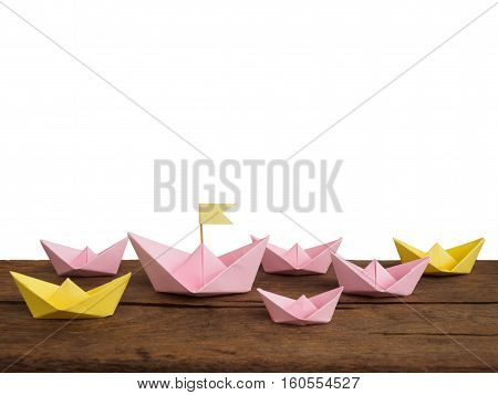 Shipping and travel concept Many paper boat(origami boat) on wooden table of white background