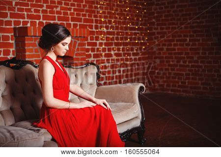 Portrait of Beautiful Sensual smilyng Woman in Fashion Red Dress. Christmas Sales and Shopping concept. Studio shot