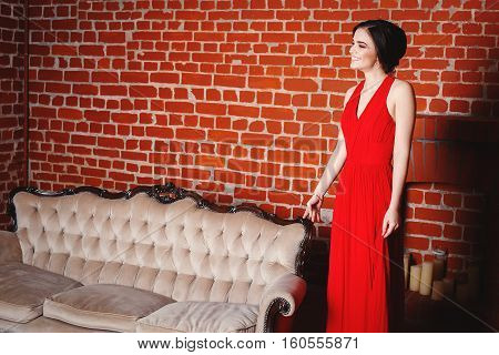 Portrait of Beautiful Sensual smilyng Woman in Fashion Red Dress. Christmas Sales and Shopping concept. Studio shot