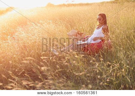 Trendy woman in casual clothes working on laptop outdoos. Freedom and freelancing concept