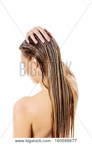 Photo of woman applying hair conditioner.