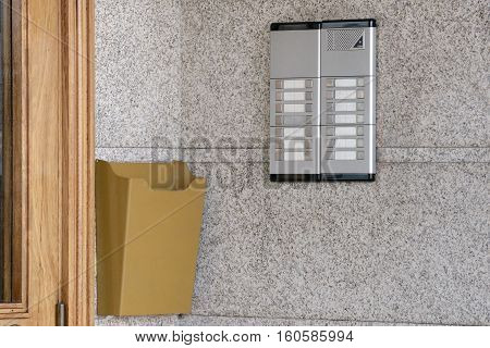image of intercom near a wooden door