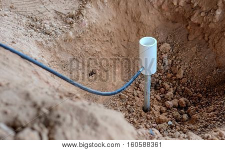 Welding copper ground wire on ground rod.