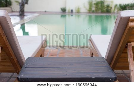 Wood Table And Pool Chair For Resting And Relaxing At Swimming Pool