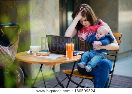 Tired Young Mother Working Oh Her Laptop