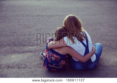 The sisters embrace each other. Relationship relatives