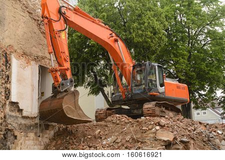 Demolition work of a house by a shovel dredge - Construction site old building