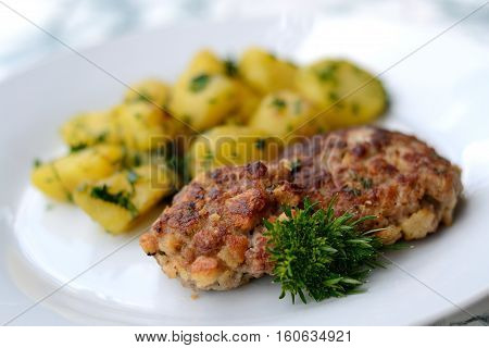 Tasty Fondant loaf with parsley potatoes - close-up