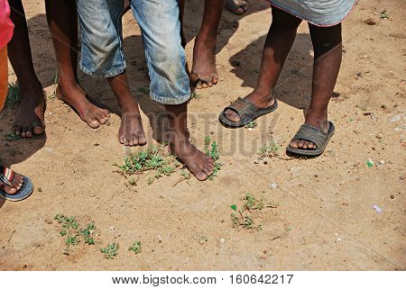 Poorness in Swaziland, Africa. Bare feet and old shoes