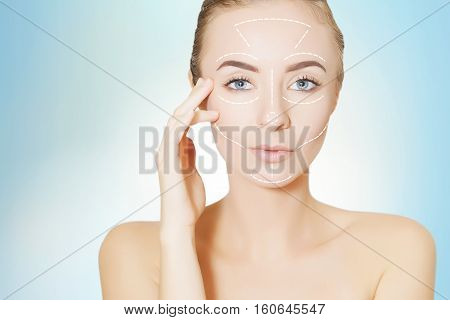 woman with surgery marks on face, blue background