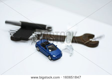 Abstract composition of broken car and repair process.