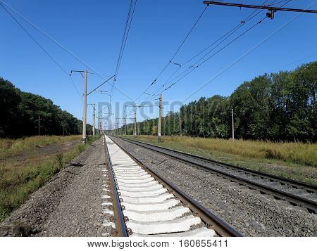 Double-track electrified railroad goes into the distance.