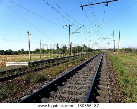 Double-track railway runs past the stopping point platform.