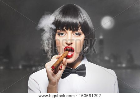 Sexy mafiosi woman boss smoke with cigar in town