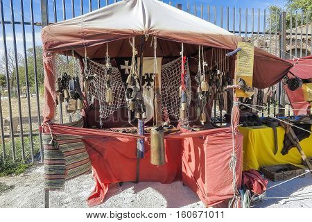 outdoor scene with a cowbells shop in the recreation of a medieval market. the market have free admission and is located on a public place