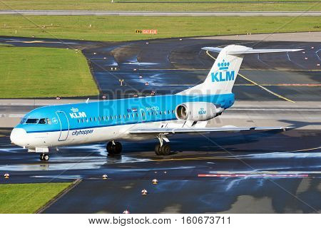 DUSSELDORF GERMANY - DEC 21 2015: KLM Cityhopper Fokker F70 taxiing after landing at Dusseldorf Airport.