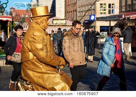 Nuremberg Germany - November 29 2016: Living statue in the most famous Christmas Market in Nuremberg city Germany. Living statues are the entertainment for the tourists