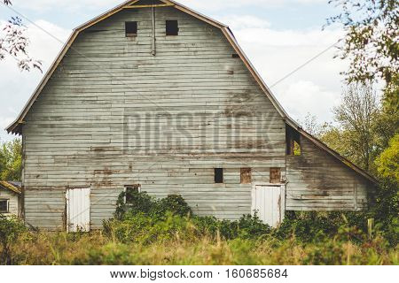 Back side of a creepy, old barn in the rural countryside near Beaverton, Oregon, USA.