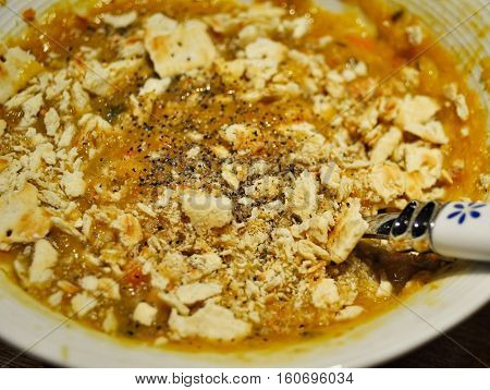 Soup with crushed soda crackers and black pepper