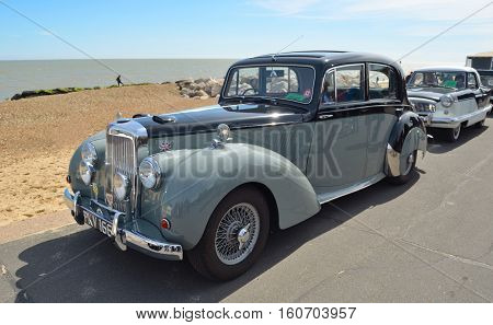 FELIXSTOWE, SUFFOLK, ENGLAND - MAY 01, 2016: Classic Alvis Grey Lady motor car parked on seafront promenade.