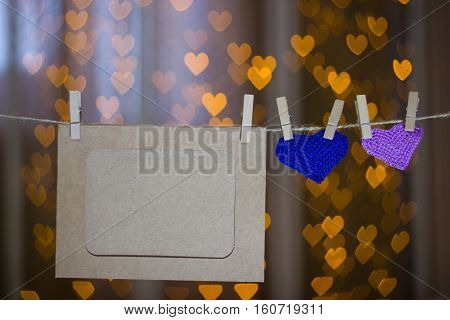 Two Knitted Heart And Photo Frames On The Clothespin.