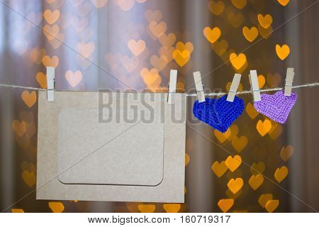Two Knitted Heart And Photo Frames On The Clothespin.