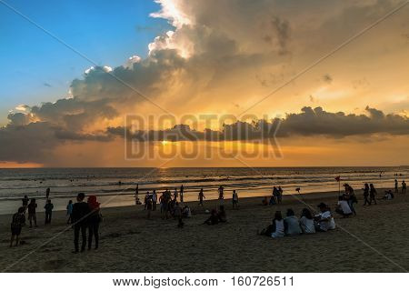 Beautiful sunset of Kuta Beach Bali Indonesia. Silhouettes of people at sunset on Kuta beach in Bali Indonesia