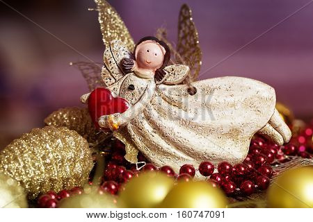vintage toy angel.Angel toy with a heart in hand on a Christmas background. Christmas card. Christmas decoration.