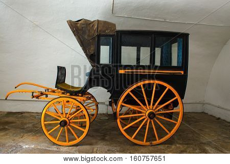 View of ancient black and yellow carriage