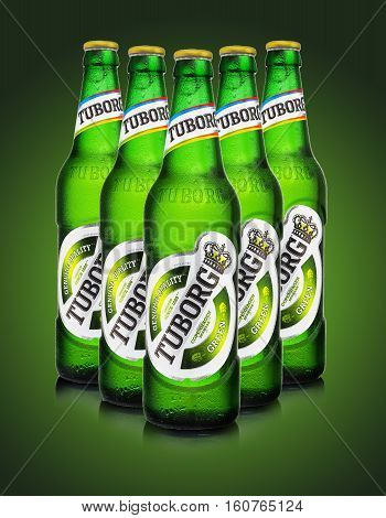 MINSK BELARUS - AUGUST 23 2016: Editorial photo of Tuborg glass bottle beer on green background. Tuborg northern suburb of Copenhagen Denmark. It has been part of Carlsberg Group since 1970