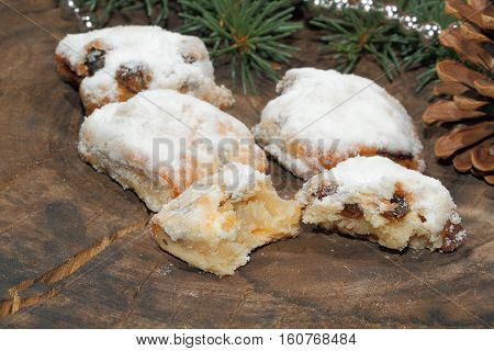 Christmas stollen with Christmas decoration on a wooden plate