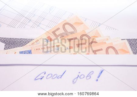 envelope with evro bills and good job sign
