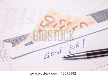 envelope with evro bills and good job sign