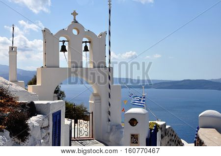 Orthodox church bells, Mediterranean sea and Santorini caldera Greece
