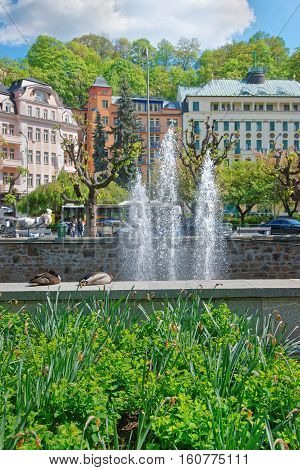 Fountain At Tepla River And Promenade Karlovy Vary