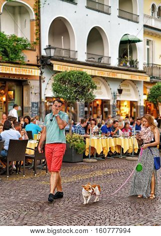 Tourists With Pet On Promenade In Ascona